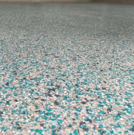close-up of epoxy flake flooring installation for homeowner patio