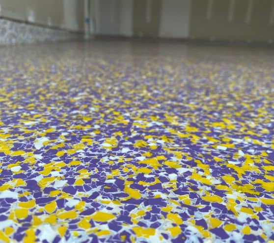 close-up of Minnesota Vikings color epoxy flake flooring for homeowner garage
