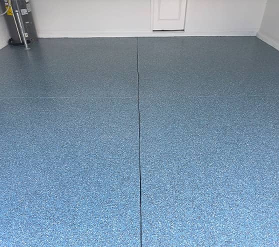 close-up of homeowner garage with blue epoxy flake flooring