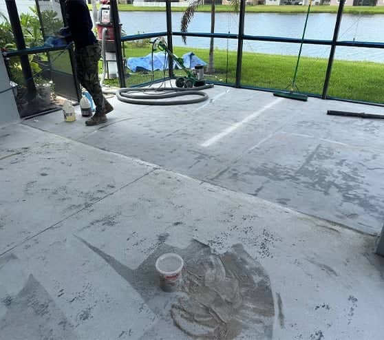 mach one employee in progress of installing epoxy flake flooring for homeowner