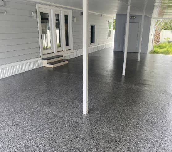 homeowner patio in florida with new gray epoxy flake flooring installed