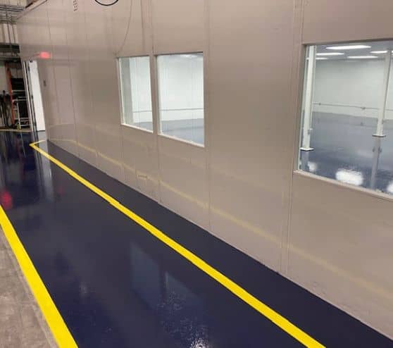 TMF Plastics warehouse with new blue solid epoxy flooring installed