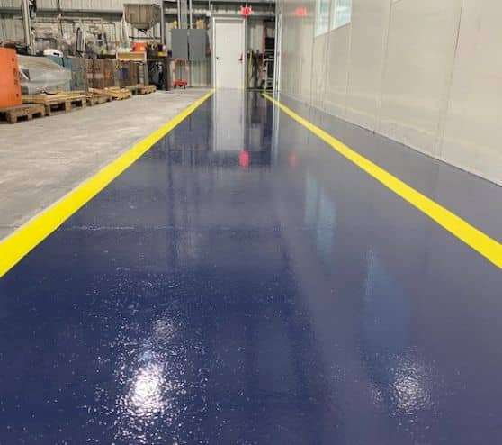 blue solid epoxy flooring freshly installed for TMF Plastics warehouse