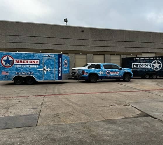 MACH ONE vehicles in front of warehouse