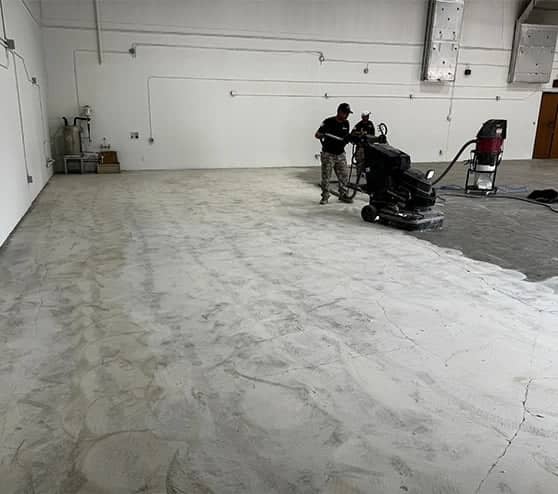 multiple men smoothing concrete floor