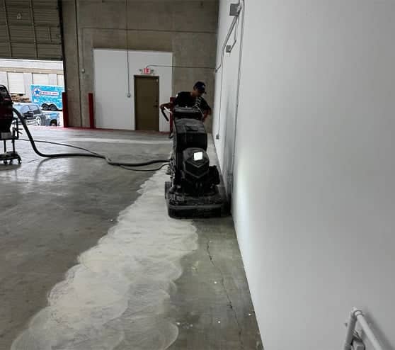gentleman using concrete machine on commercial flooring