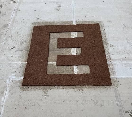 close-up of an "E" on homeowner patio