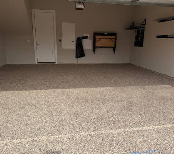 front view of homeowner garage with new epoxy flooring installed after portrait