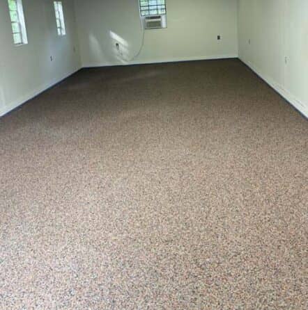 a room with new red epoxy flake flooring