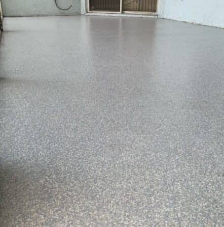 back patio with coastal blue epoxy flake flooring for homeowner