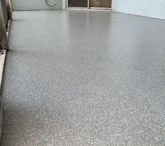 back patio with coastal blue epoxy flake flooring for homeowner