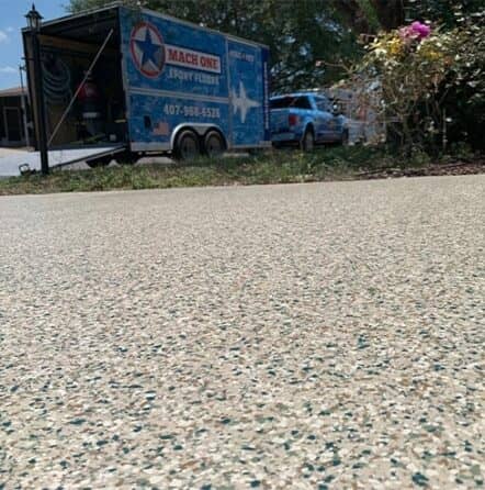 close-up of new epoxy flooring for homeowner with mach one truck in background