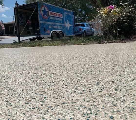 close-up of new epoxy flooring for homeowner with mach one truck in background