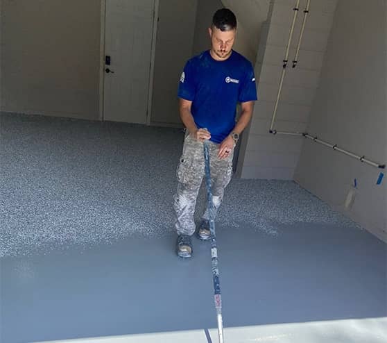 close-up of employee working on garage floor for homeowner
