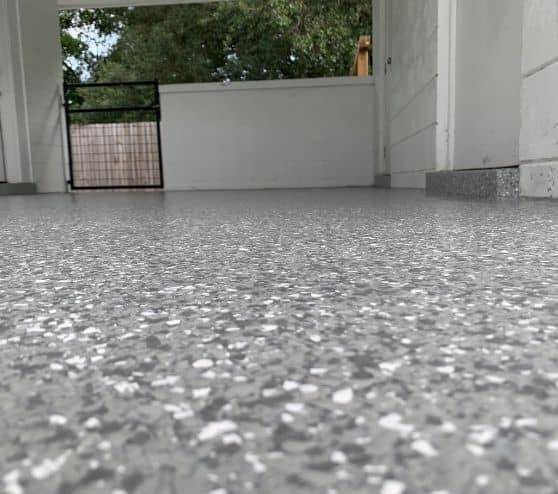 epoxy flake flooring installed for homeowner laundry room and car port