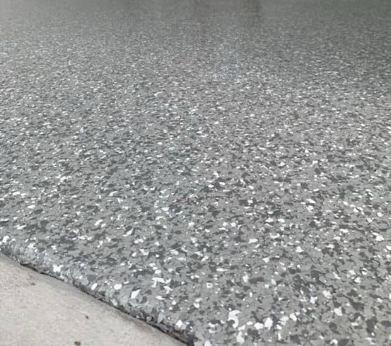 homeowner car port with new epoxy flake flooring installed