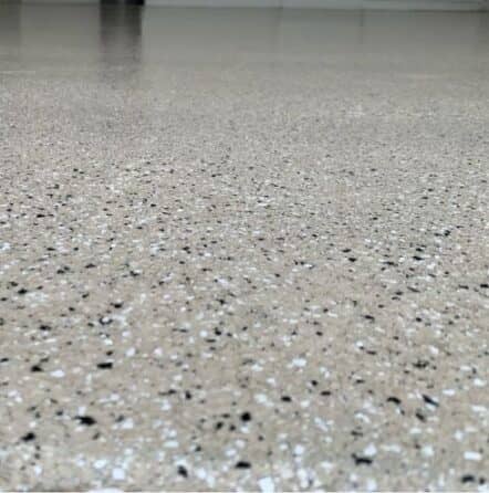 tan epoxy flake flooring installed for Cari two car garage close-up