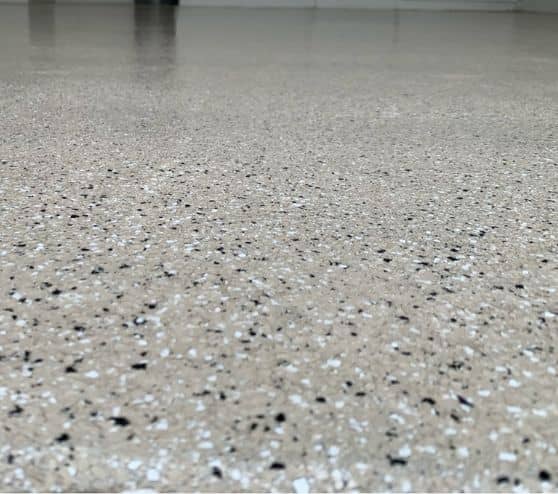 tan epoxy flake flooring installed for Cari two car garage close-up