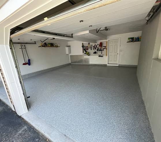 two car garage with fresh epoxy flake flooring