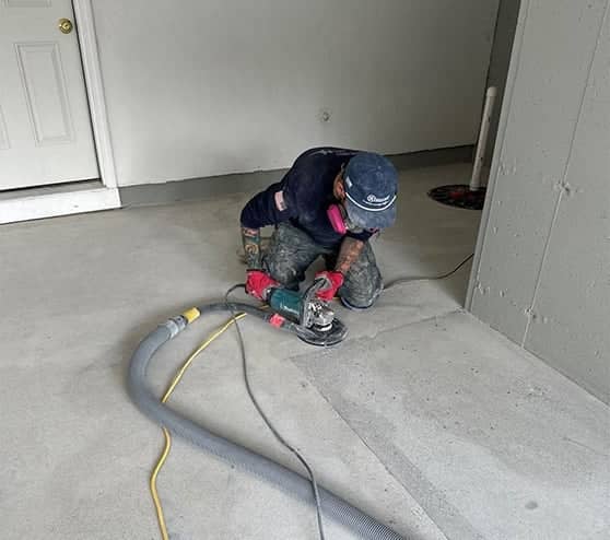 gentleman repairing flooring in garage