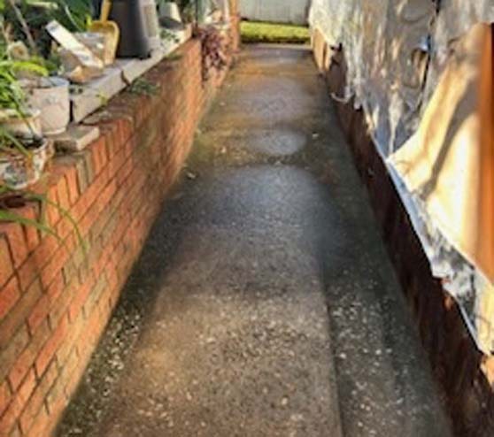 a concrete path beside a house