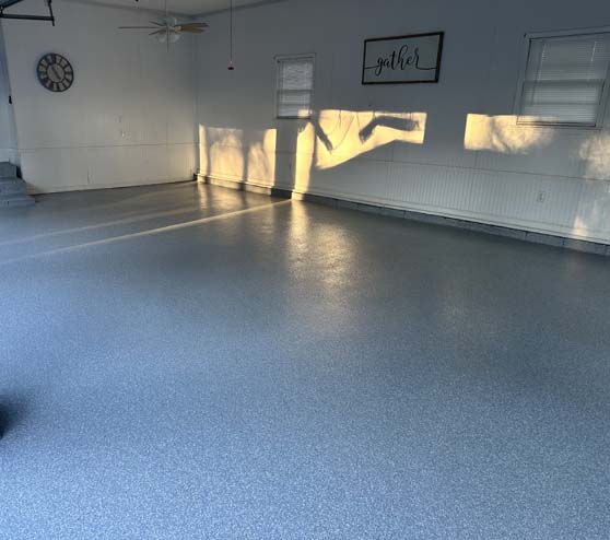 a garage floor with new epoxy flake flooring
