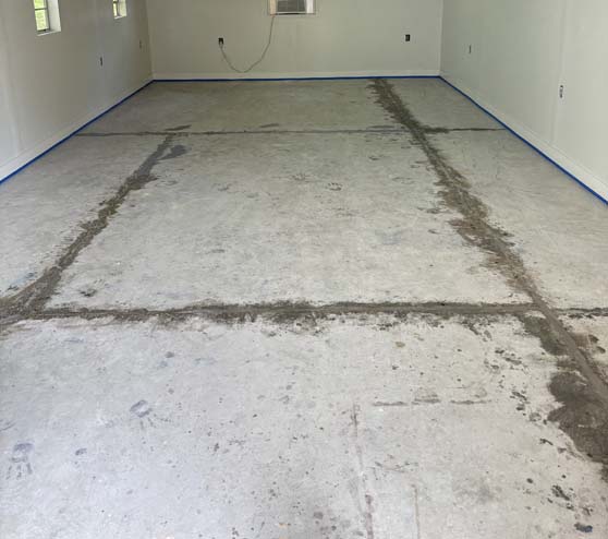 a room in need of concrete floor repairs