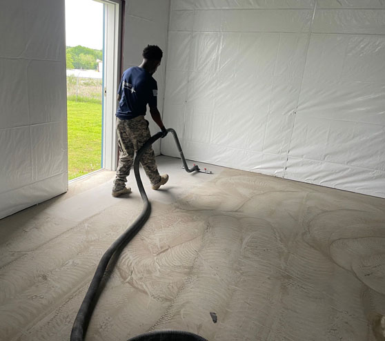 employee working on epoxy flake flooring project in Burleson, TX