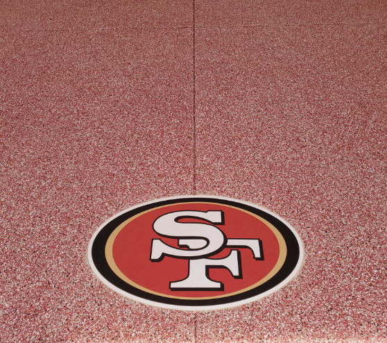 football logo and red epoxy flake floor in Fresno, CA
