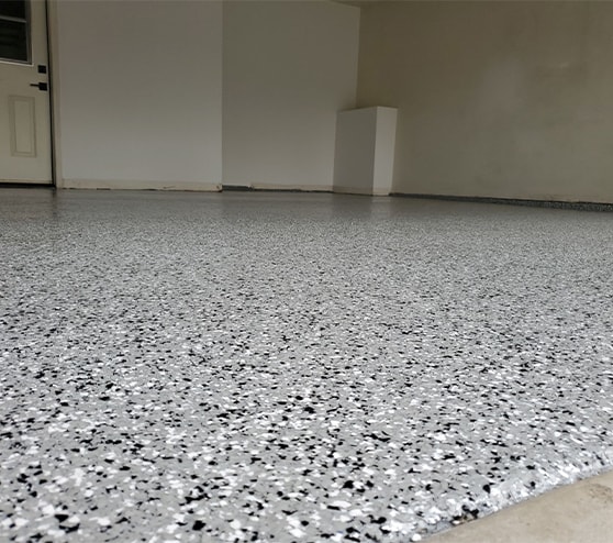 close-up of garage floor with new epoxy flake flooring