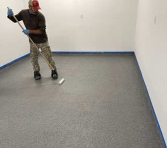 man installing graniflex flooring in condo garage