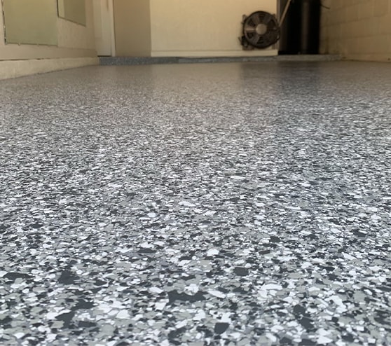 close up of flake epoxy flooring in garage
