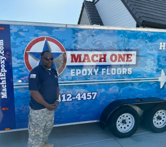 MACH ONE employee standing by a truck