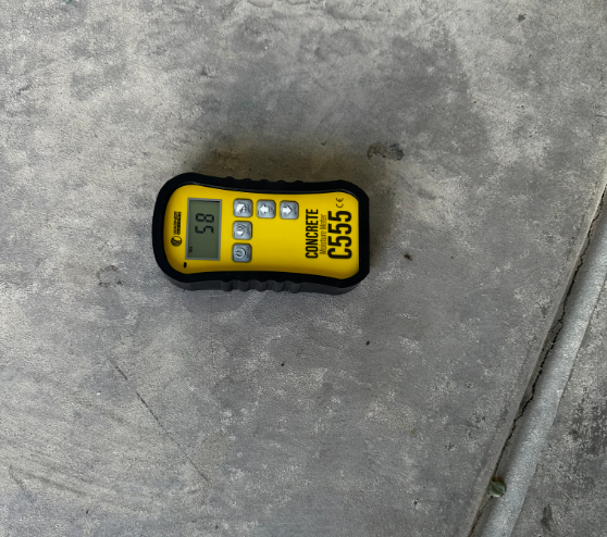 moisture meter laying on concrete