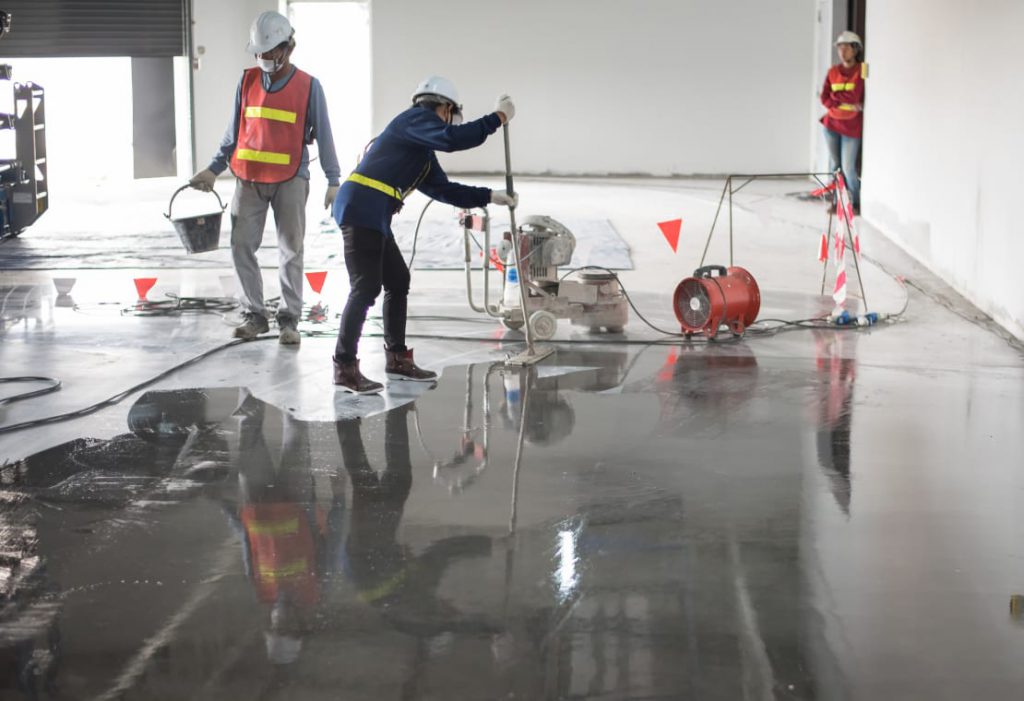 mach one team installing epoxy floor