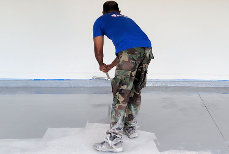 gentleman installing epoxy floor in garage